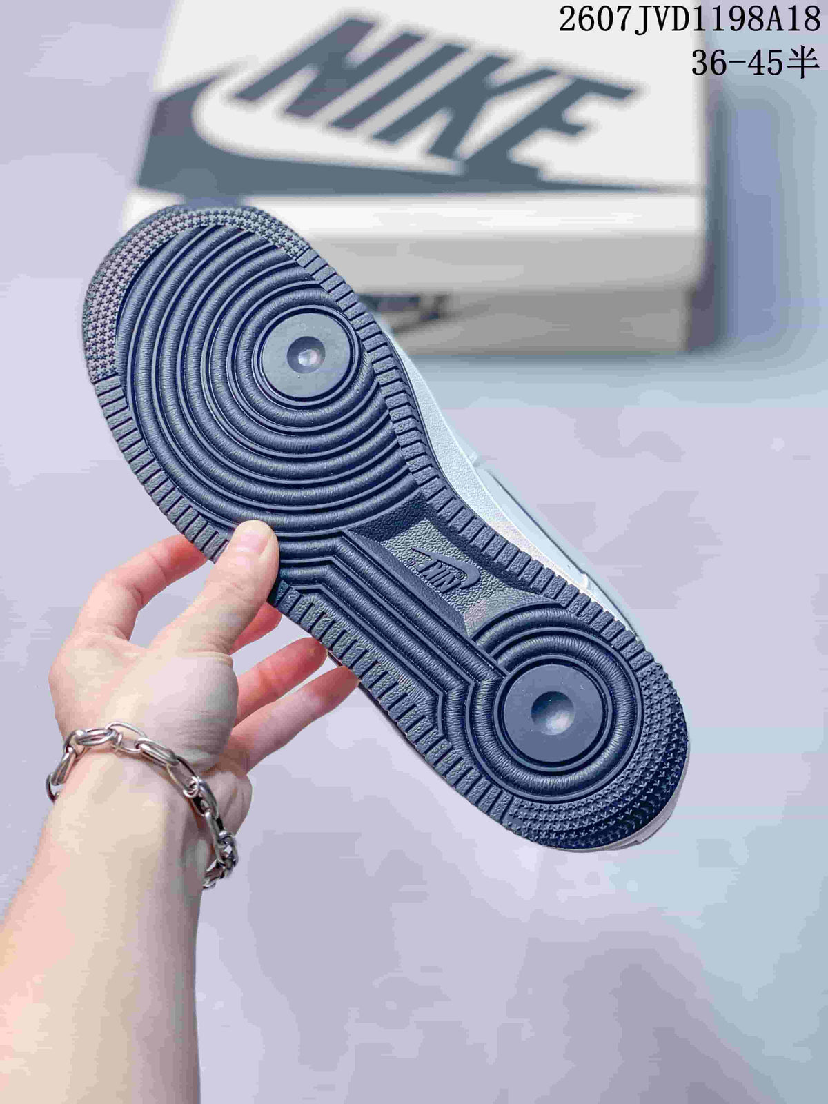 Close-up of the dark textured rubber outsole with circular pivot details.