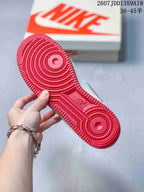 Close view of the red rubber outsole showing concentric traction circles and molded tread details.