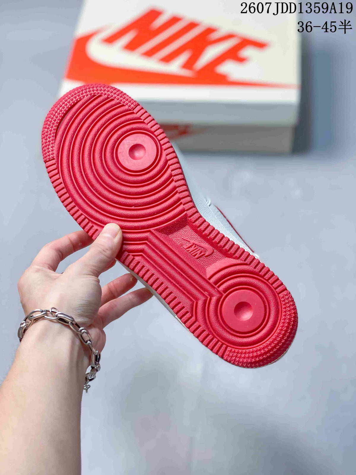 Close view of the red rubber outsole showing concentric traction circles and molded tread details.