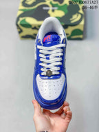 Top view of a blue and white sneaker with a perforated white toe box, white laces, and a decorative lace accessory.