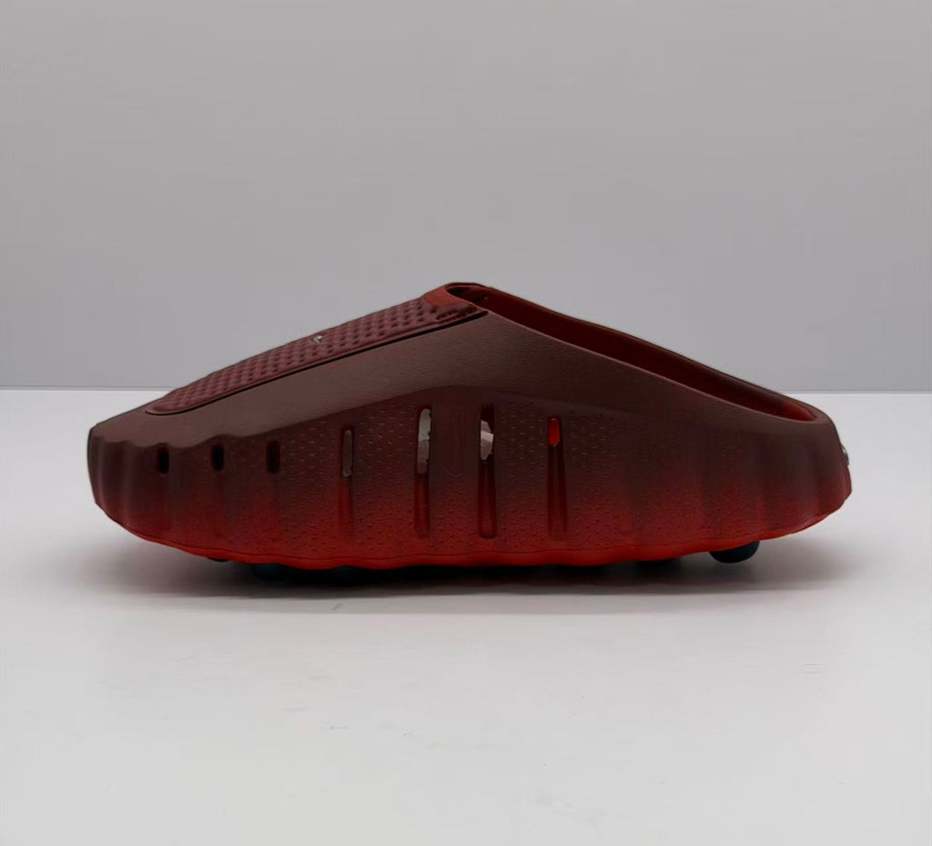 Side profile showing ventilation openings along the dark red sneaker upper and black outsole elements.