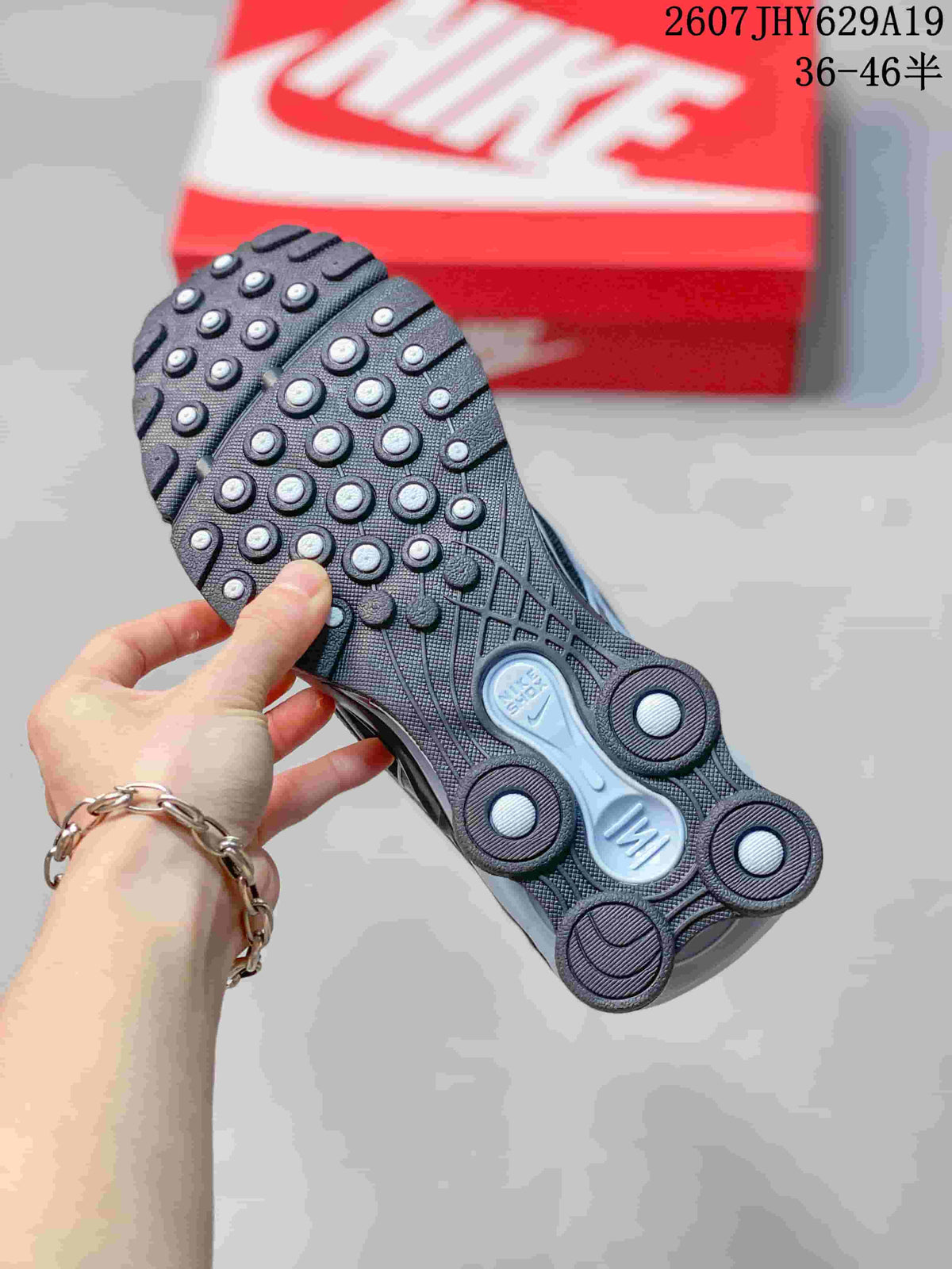 Underside view showing the patterned outsole and circular traction elements of the sneaker.