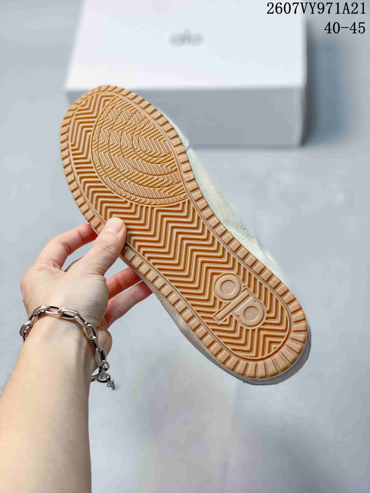 Close-up of the gum-colored outsole showing a geometric tread pattern and Alo branding.