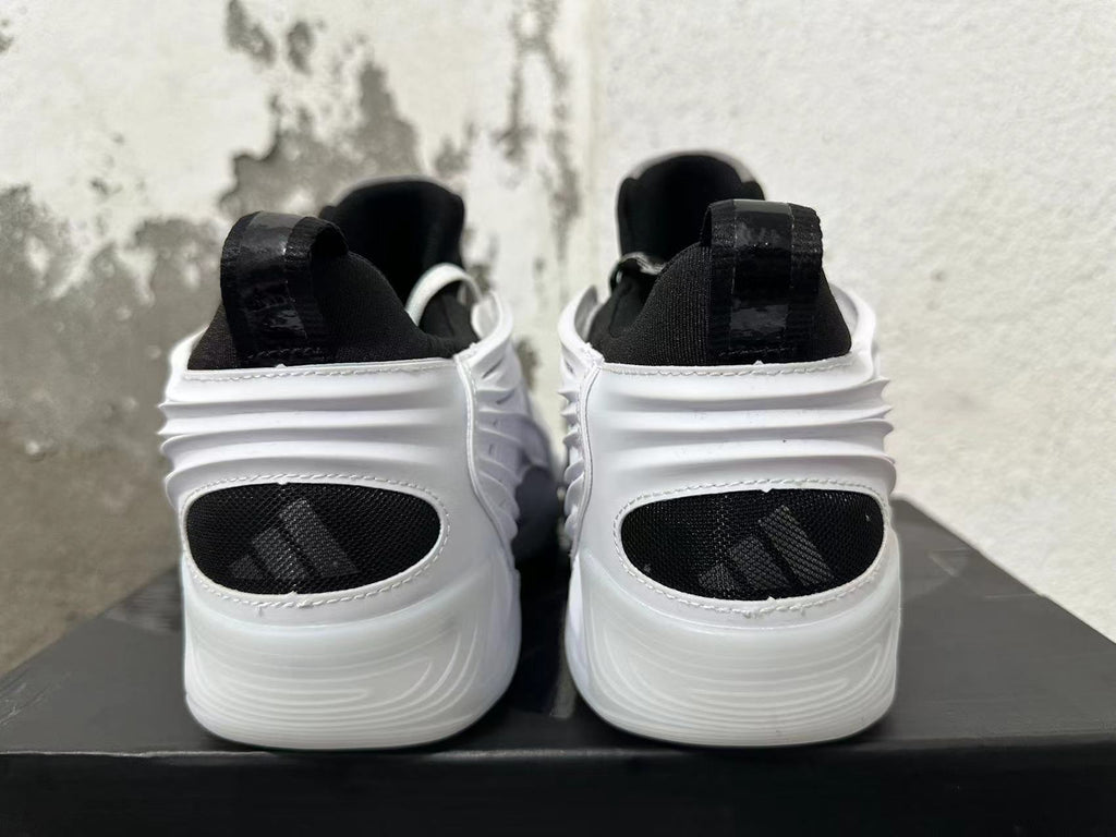 Rear view of white and black sneakers with sculpted heels and black heel panels
