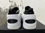 Rear view of white and black sneakers with sculpted heels and black heel panels