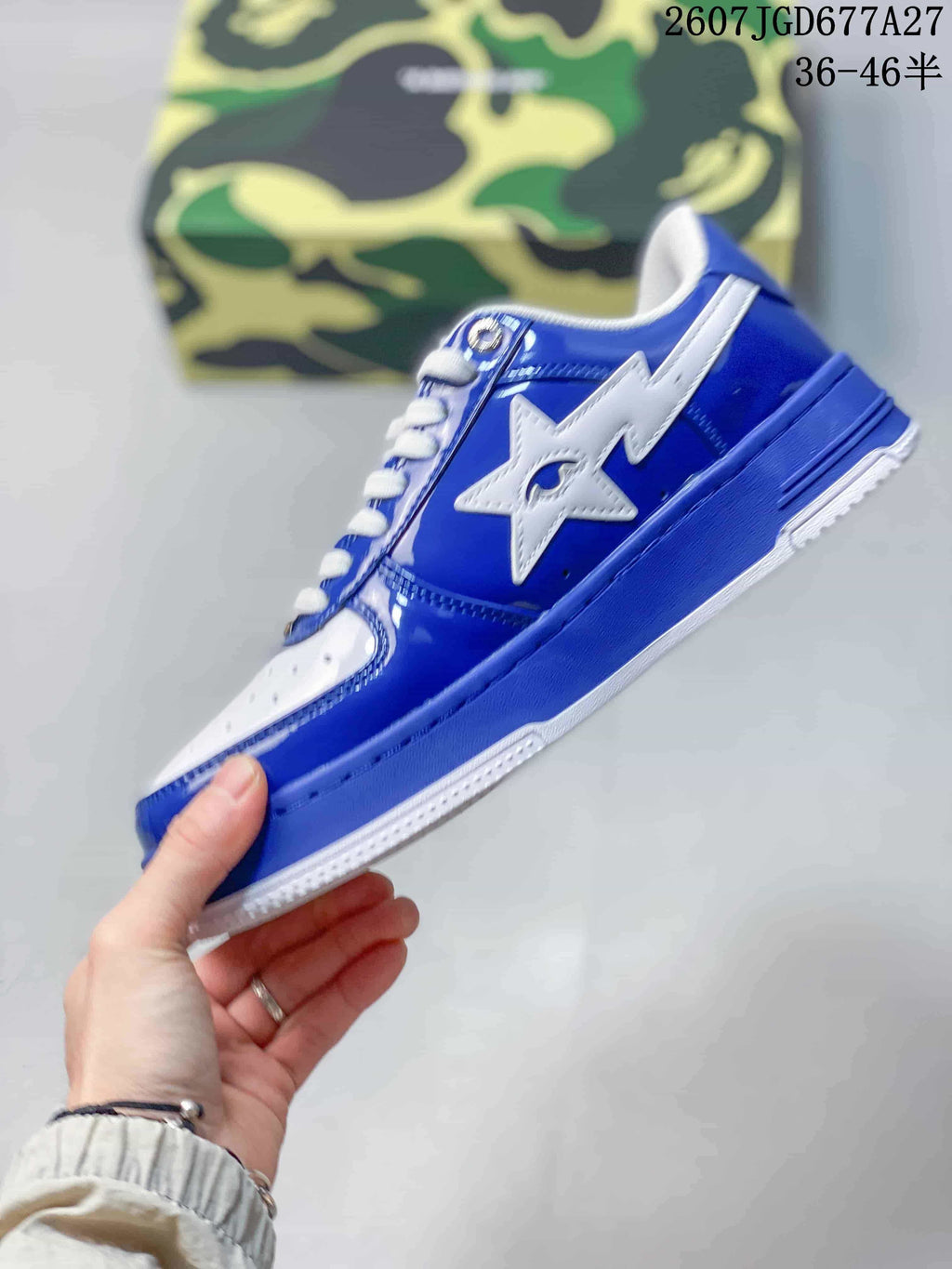 Side profile of a blue and white low-top sneaker with a large white star logo and layered blue sole.