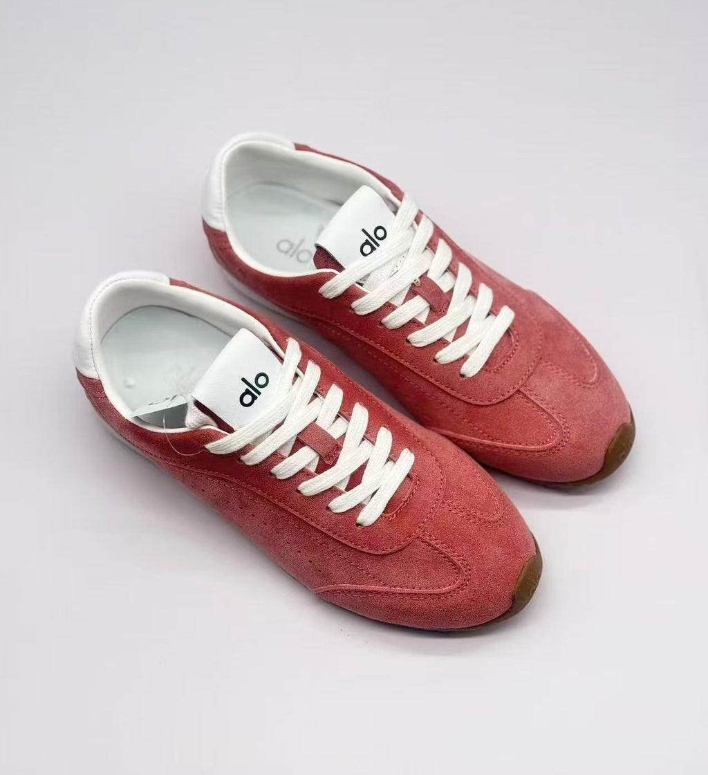 Top-down view of the pair showing the lace layout, pink uppers and white interiors.