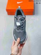 Front view showing the rounded toe, gray laces, padded collar, and layered upper design.