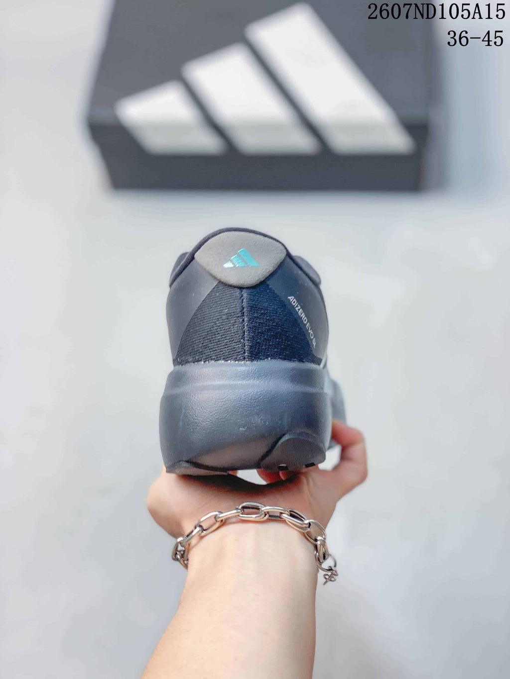 Rear view of the sneaker showing the padded heel collar, heel branding and thick dark outsole.