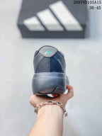 Rear view of the sneaker showing the padded heel collar, heel branding and thick dark outsole.