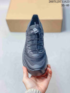 Front view of the black sneaker showing the textured upper, cord-style lacing, and rounded toe.