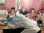 Side view of a white Jordan basketball sneaker showing stitched overlays, red speckled accents and a translucent outsole.