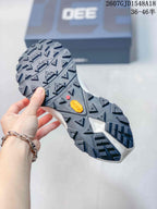 Close view of the heavily lugged outsole with visible Vibram branding and size-range text in the image.