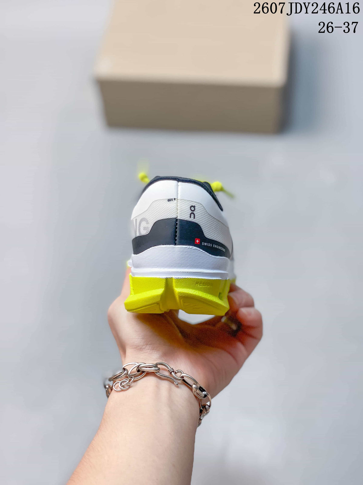 Rear view of the white shoes showing black heel detailing, On branding, and lime outsole sections.