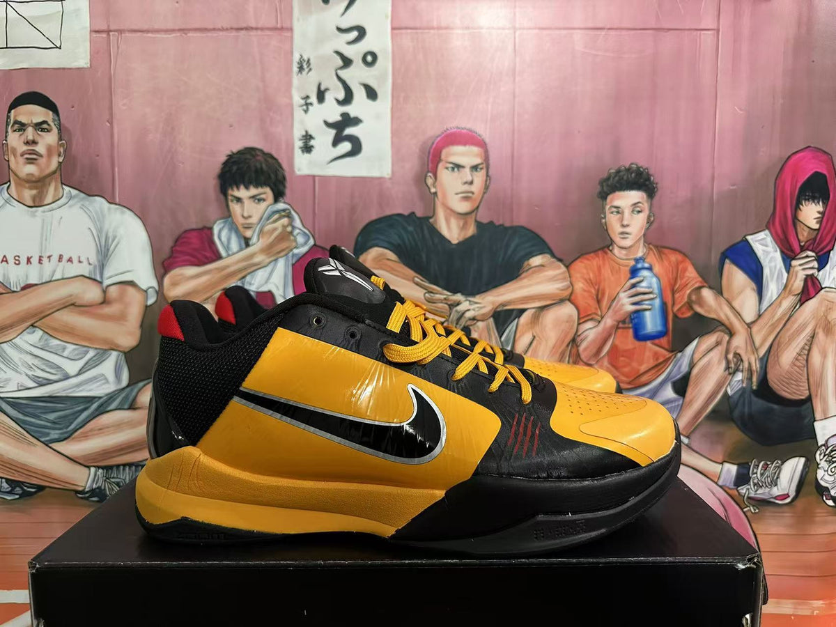 Side view of a yellow and black Nike basketball shoe with a visible Swoosh