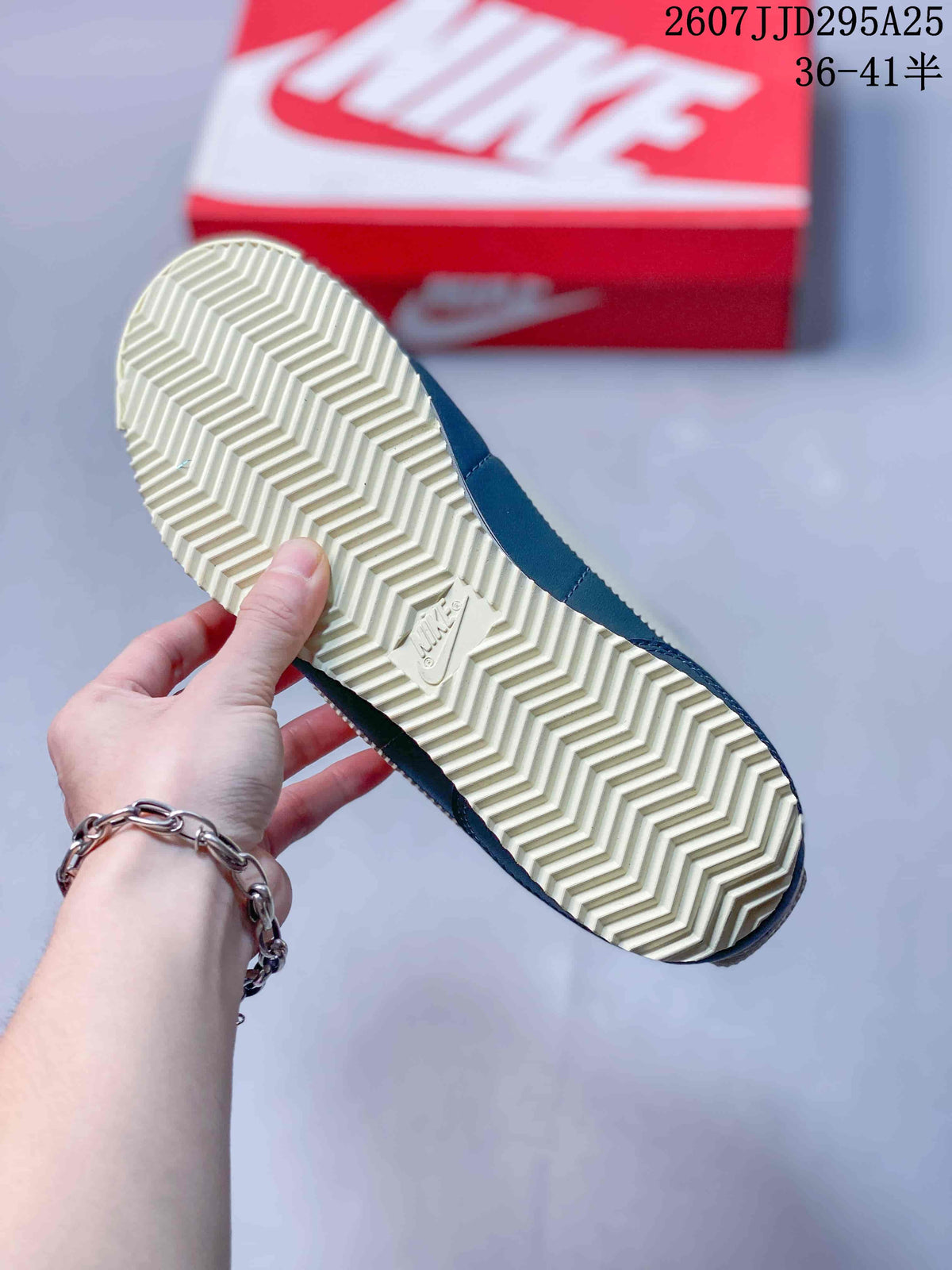 Close view of the cream rubber outsole with a repeating herringbone tread pattern and Nike branding.
