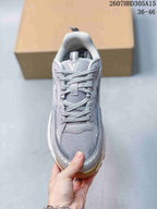 Top view of the gray lace-up sneaker showing the padded tongue, laces, mesh toe panel, and visible Louis Vuitton branding.