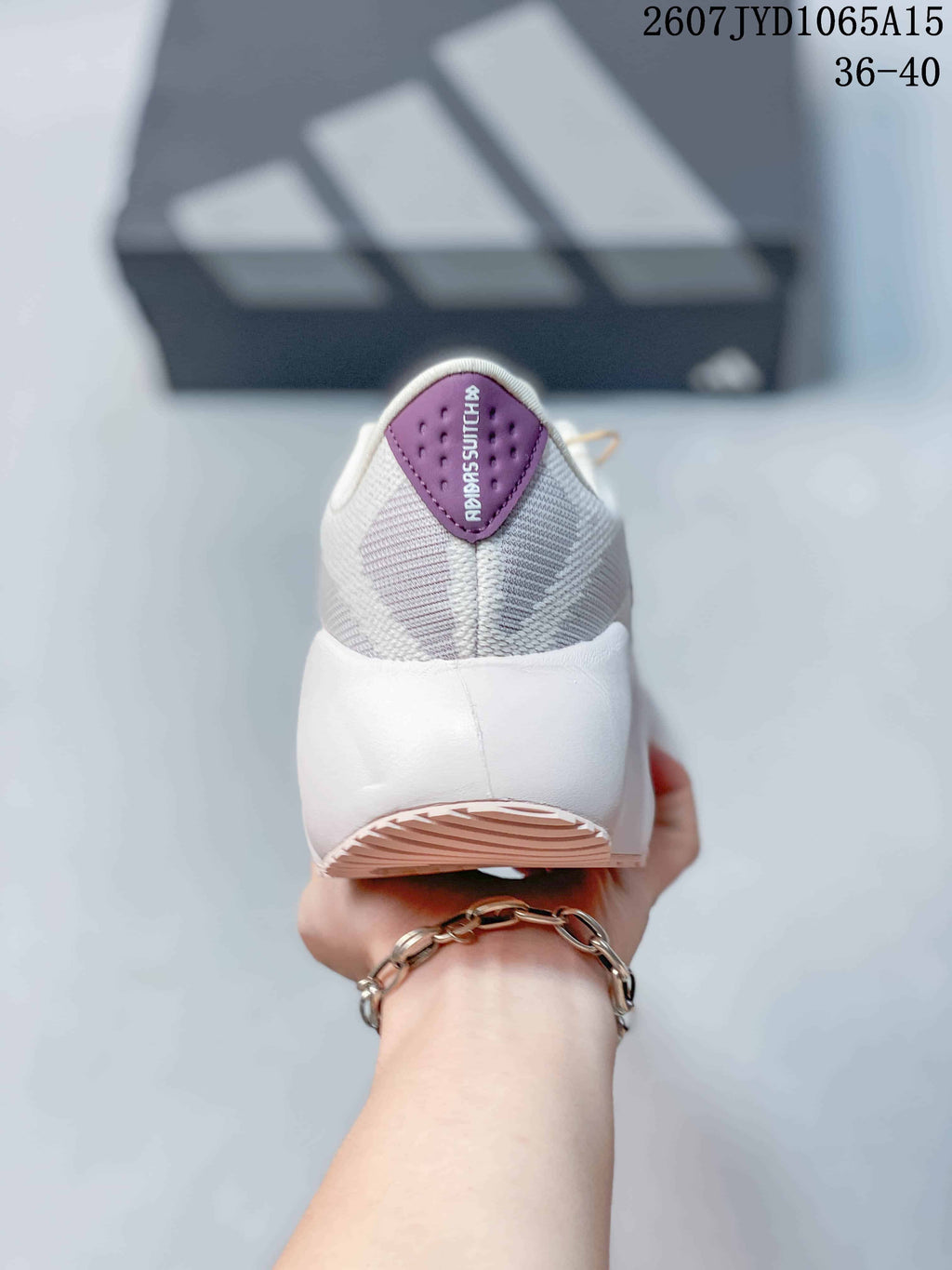 Rear view showing the textured heel, white heel structure, and pink outsole accent.