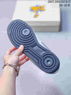 Close-up of the dark rubber outsole with concentric circular traction patterns and a central embossed logo.