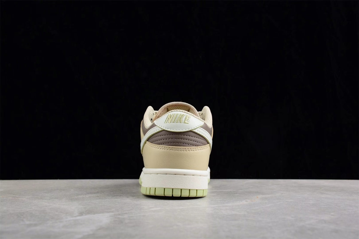 Rear view showing the beige heel, layered brown detailing, white midsole, and light green outsole.