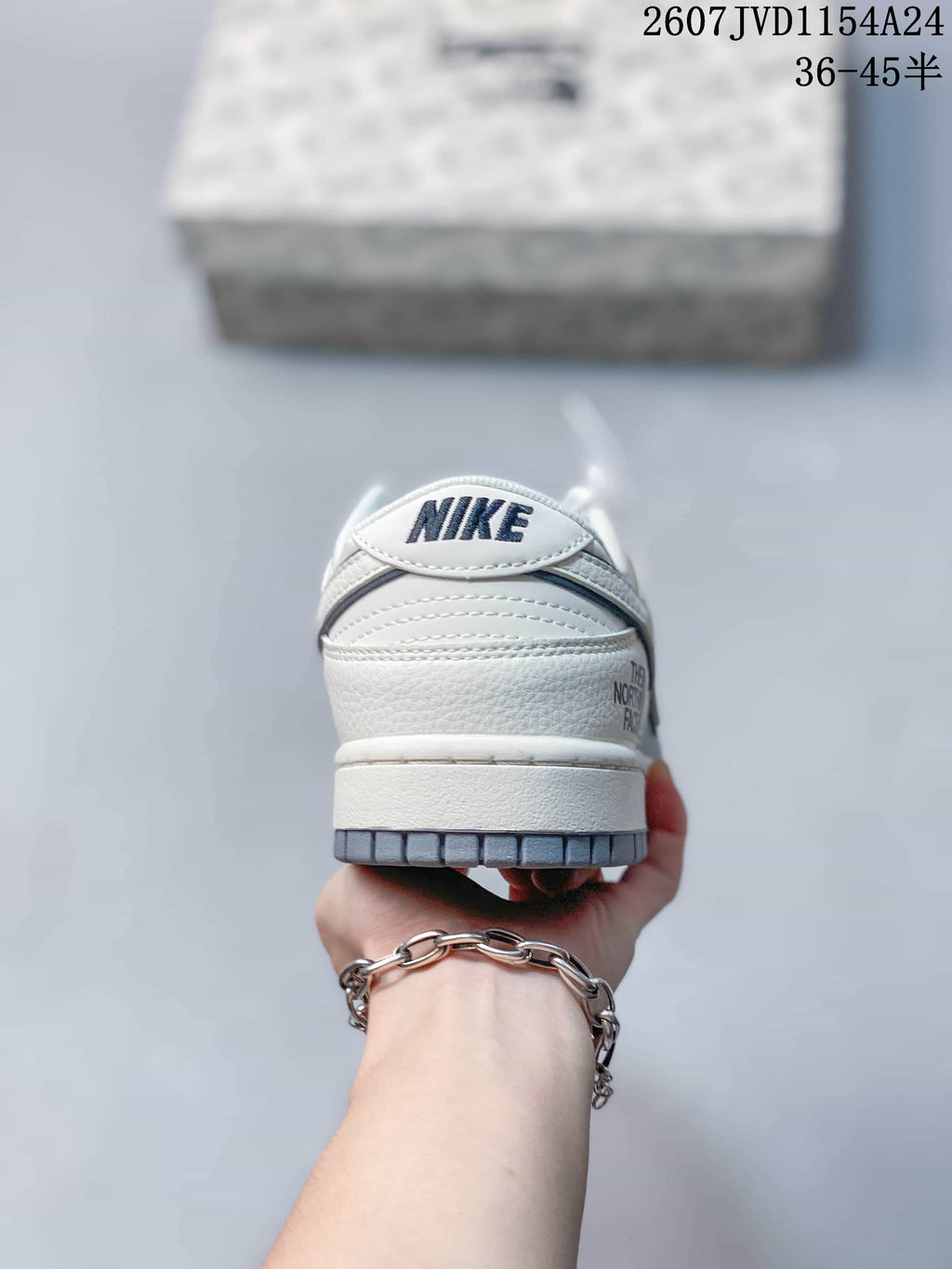 Rear view of the sneaker showing the padded heel, Nike tongue branding and grey outsole edge.