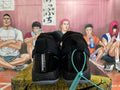 Rear view of black Nike basketball sneakers with blue accents, padded collars and translucent soles.