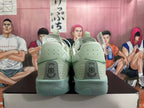 Rear view of pale green Nike G.T. Jump 2 basketball shoes showing heel details and perforations