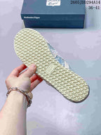 Close view of the cream-colored textured outsole of the sneaker, with an Onitsuka Tiger mark visible near the midfoot.