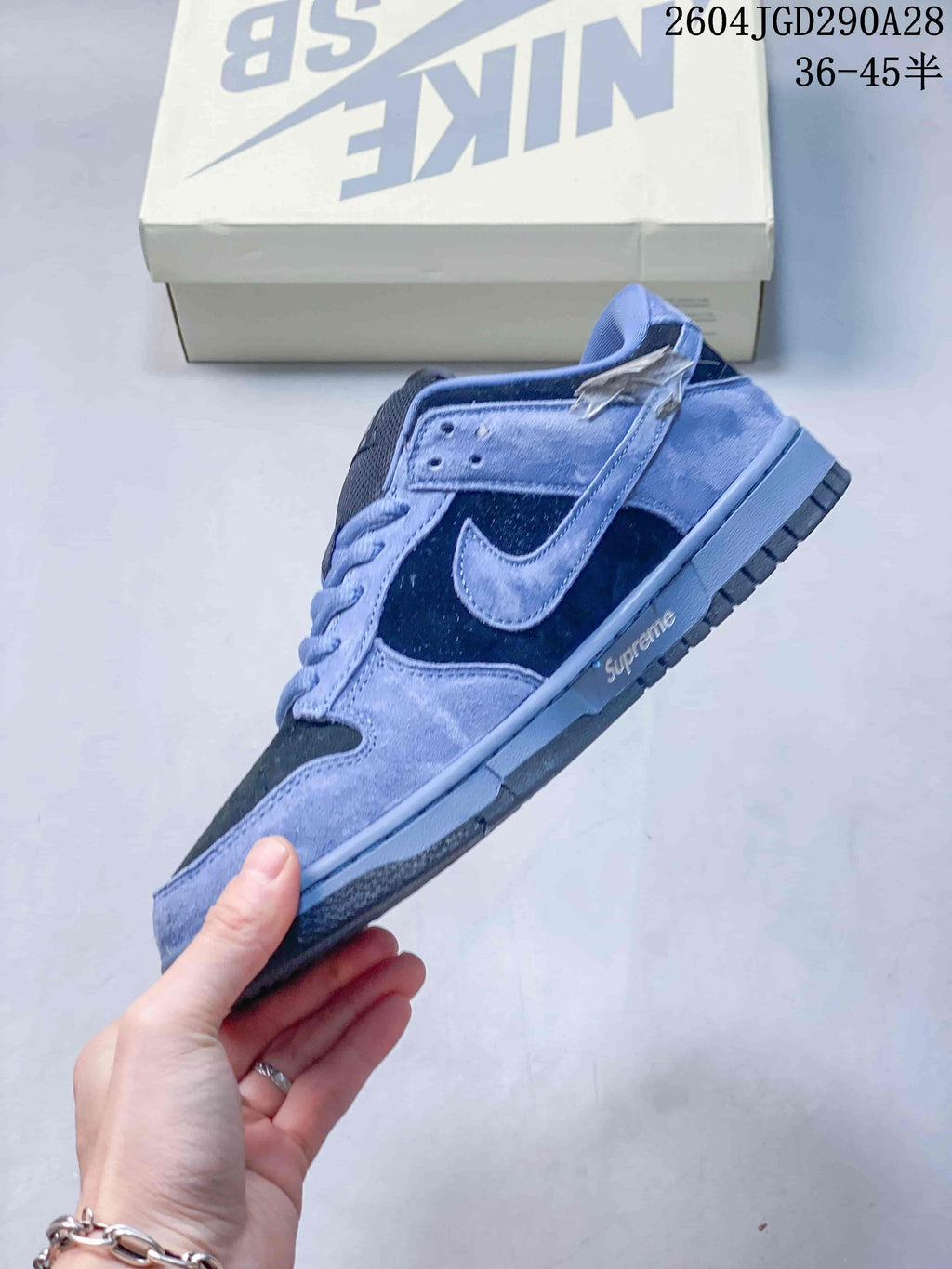 Side profile showing the Swoosh and contrasting panels on a blue Nike SB Dunk Low Pro sneaker