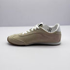 Opposite side view of the beige low-top sneaker with perforated side detailing.