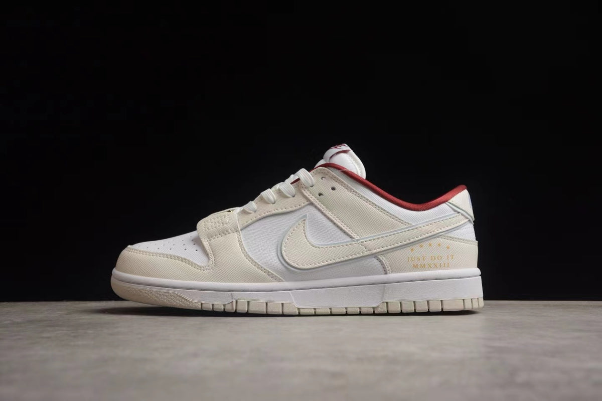 Side profile showing the off-white low-top design, white side branding, red collar accent, and rubber outsole.