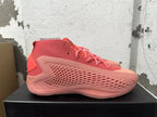 Side profile showing the textured upper and sculpted panels of the pink sneakers.