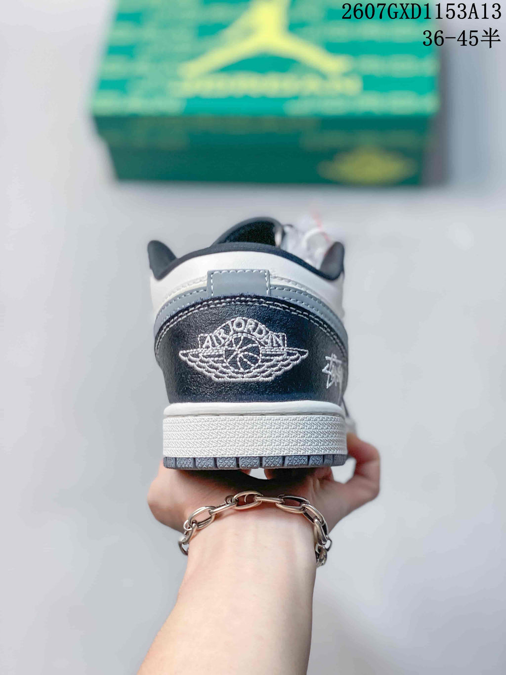 Rear view showing the embroidered winged basketball logo and layered heel construction.