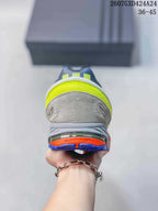 Rear view of the sneaker showing a neon yellow heel panel, gray upper and blue outsole with orange detailing.
