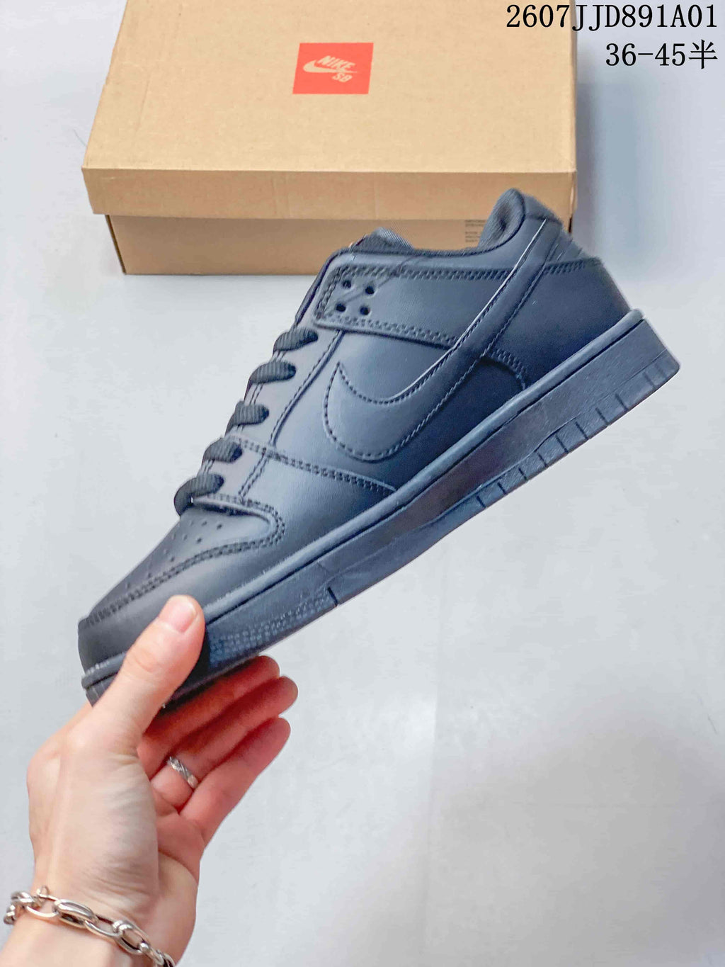 Side profile of a dark gray Nike Dunk Low sneaker
