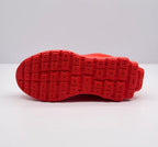 Underside view showing the patterned red outsole tread.