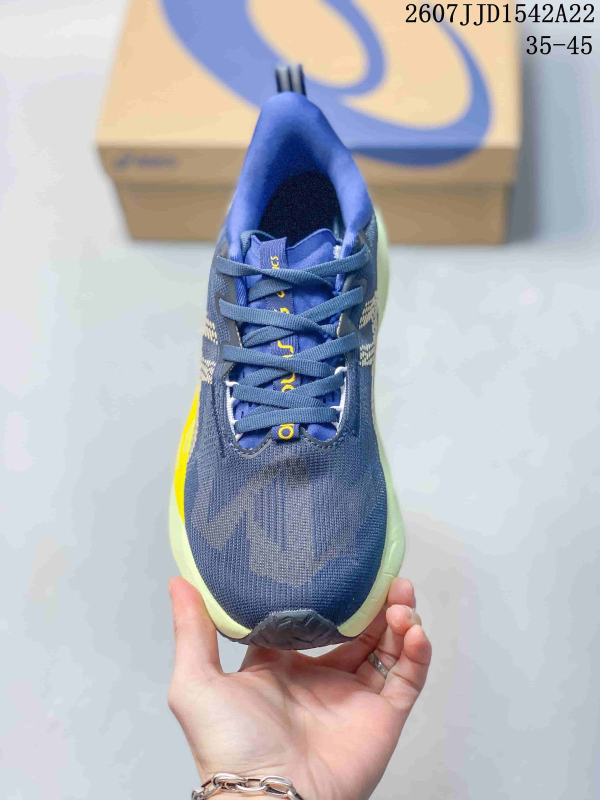 Top view showing the lace-up construction, navy upper, blue tongue and lime outsole edge.