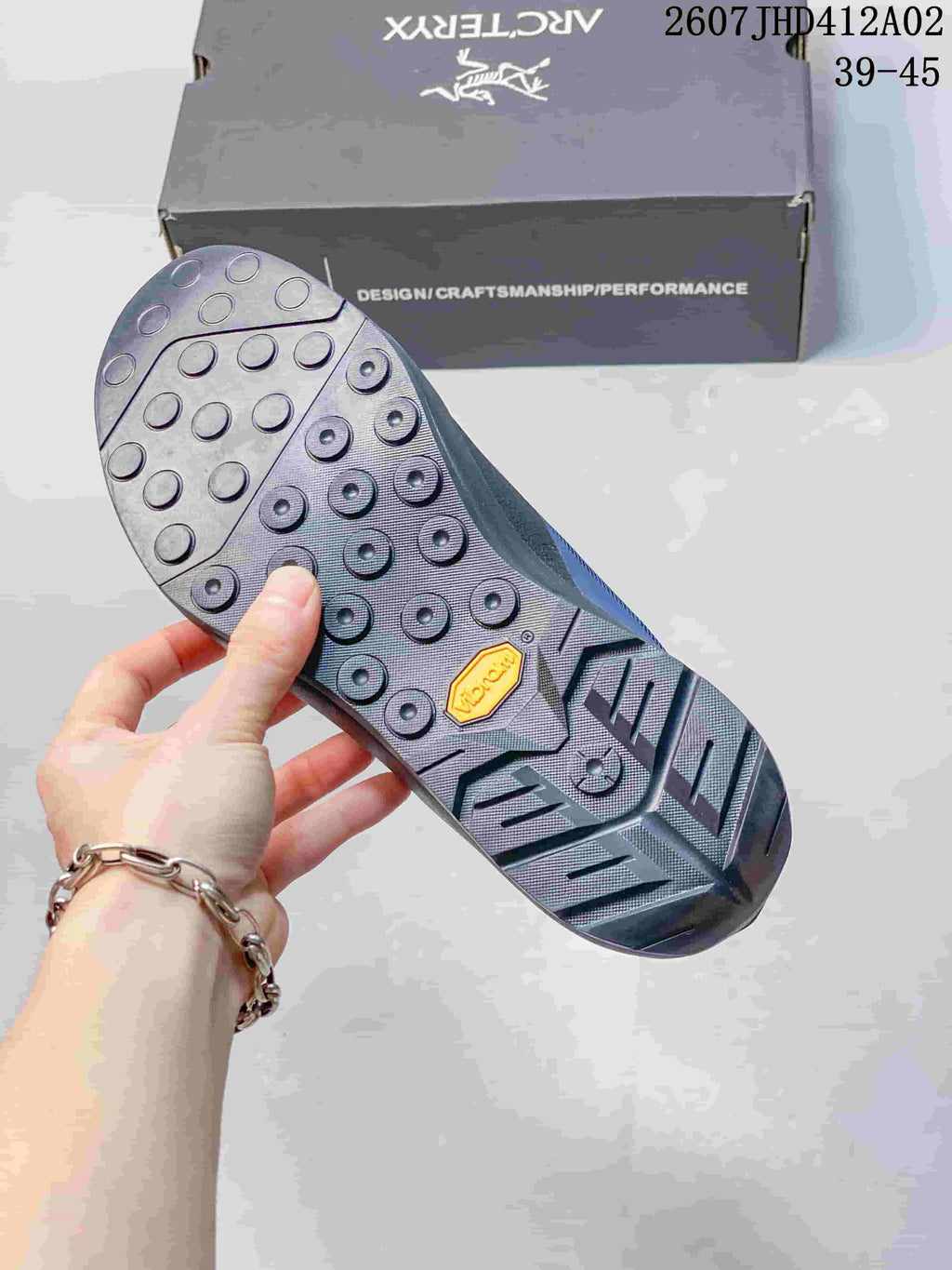 Close-up of the shoe outsole showing circular and angular tread details