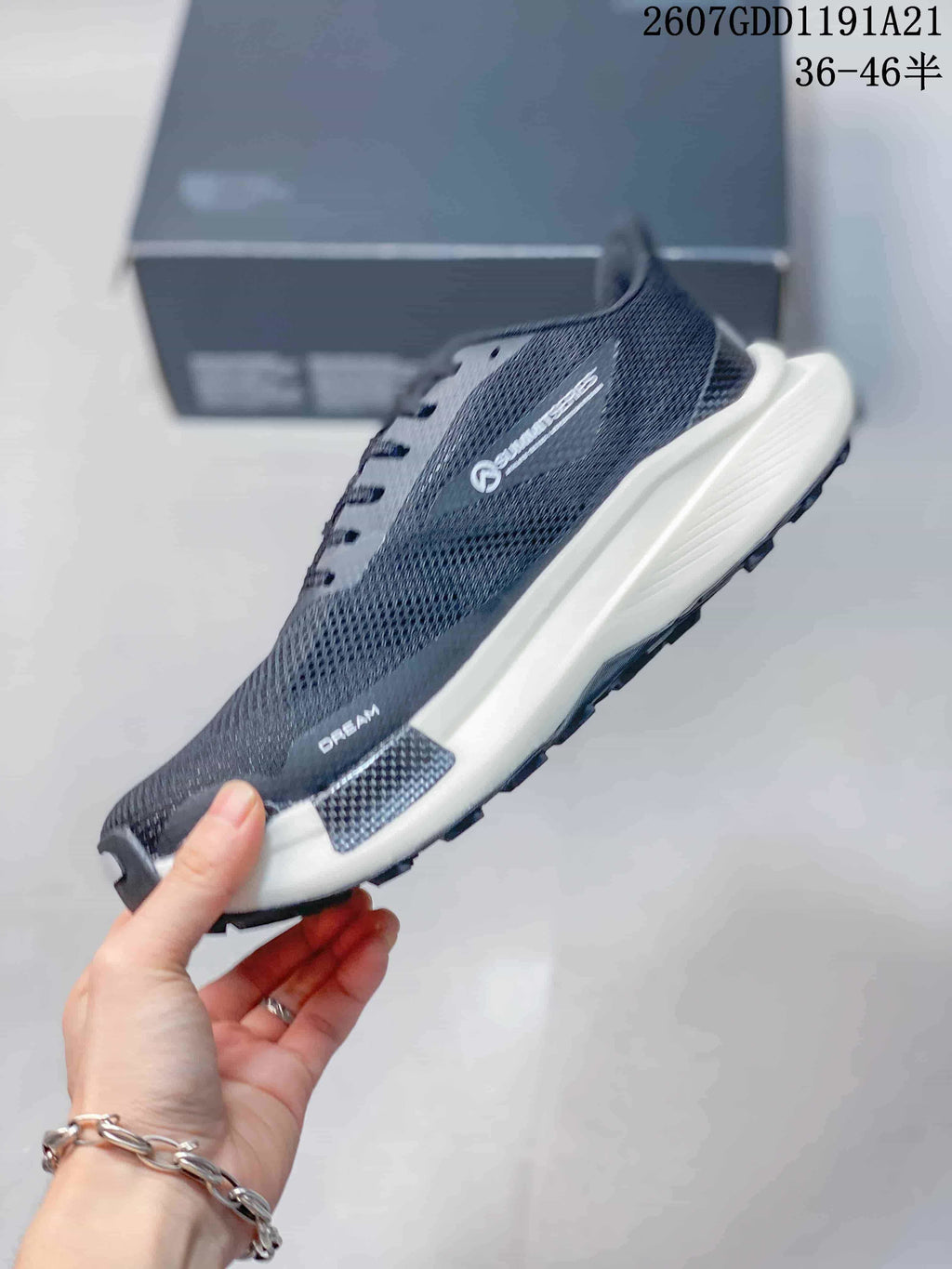 Side profile of the dark gray sneaker showing the mesh upper, white midsole, carbon-look side detail, and Summit branding.