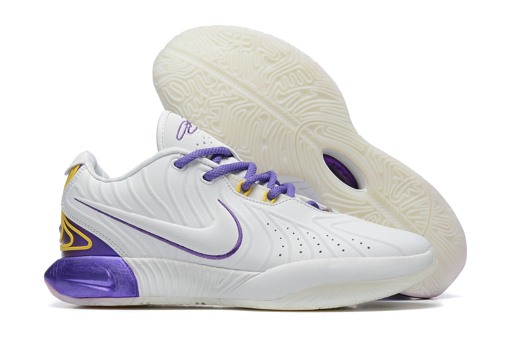 White Nike basketball shoes with purple and yellow accents.