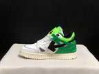 Side profile showing the low-top silhouette, green heel and collar panels, and large black arrow detail.