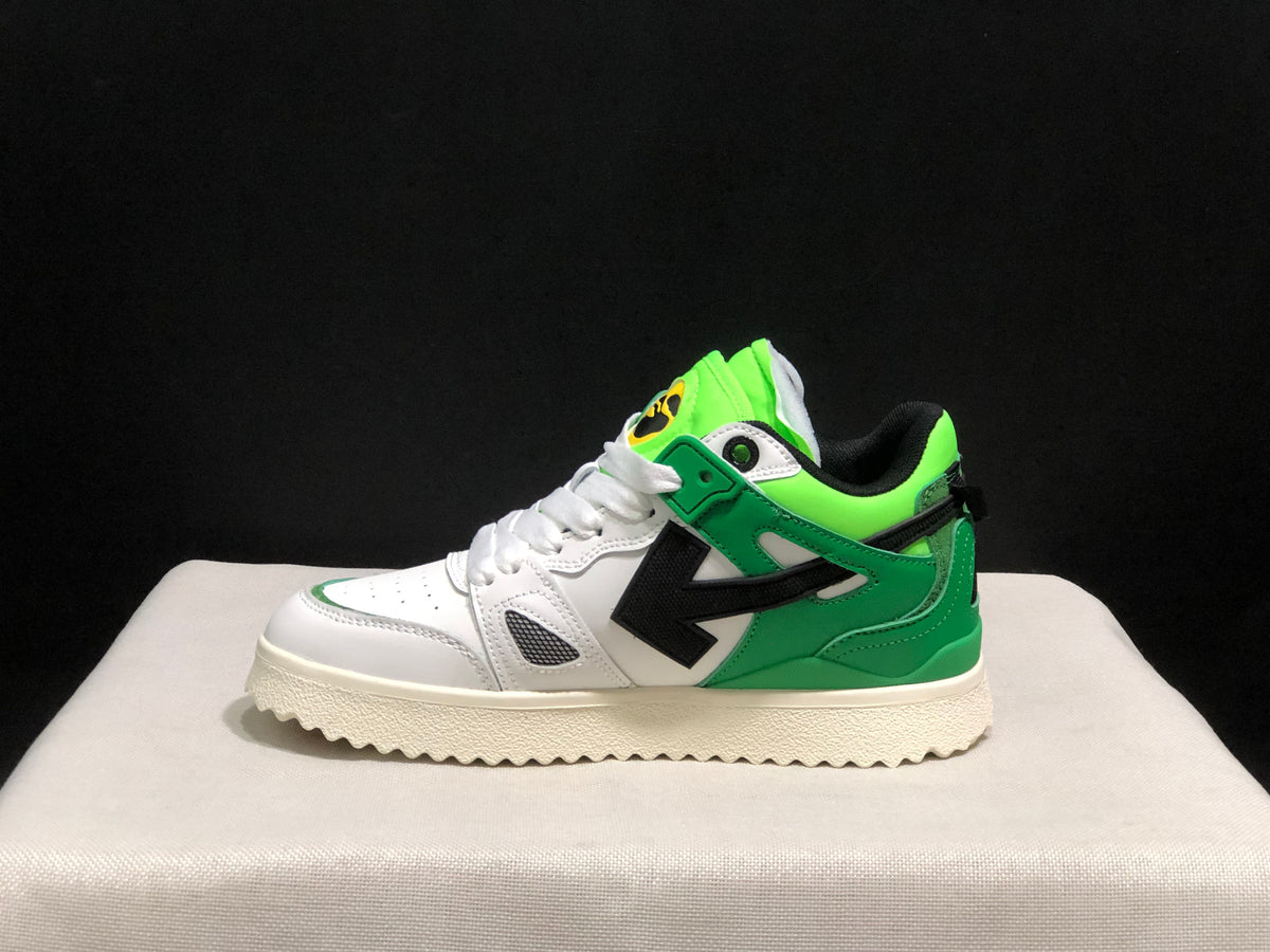 Side profile showing the low-top silhouette, green heel and collar panels, and large black arrow detail.