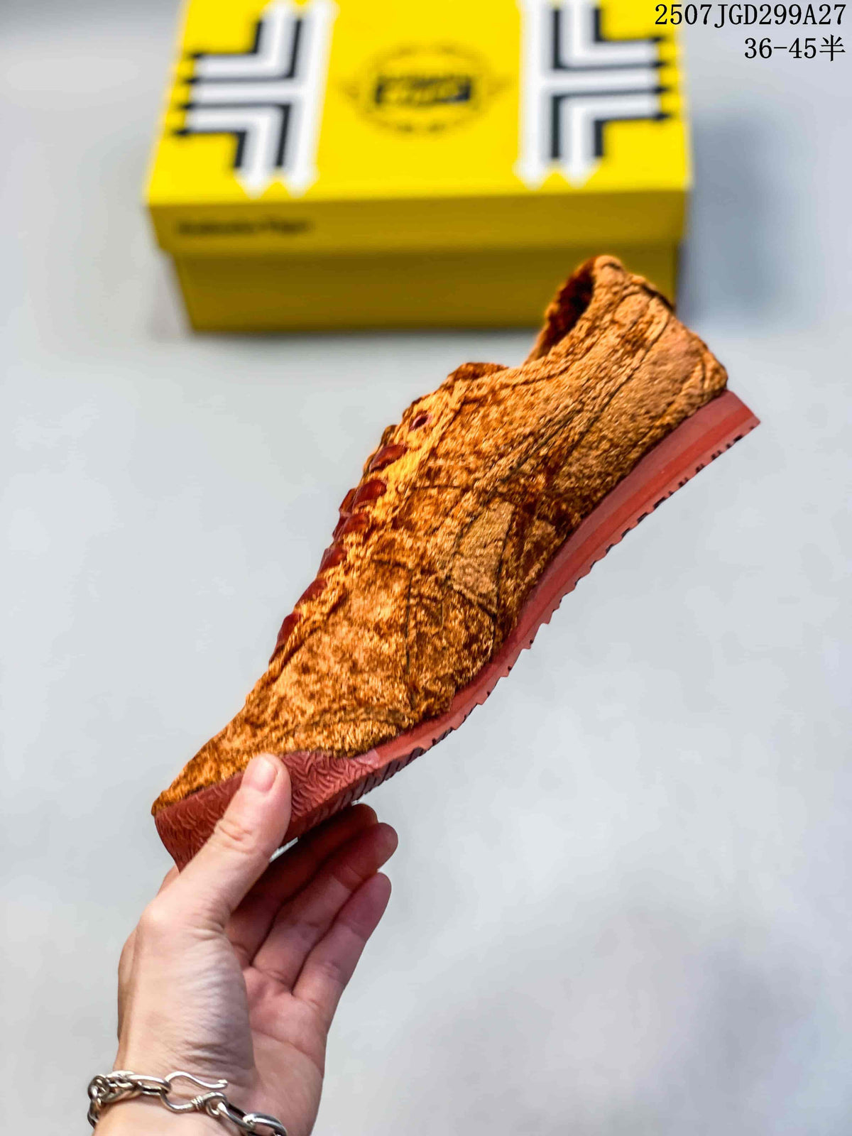 Side profile of the textured brown sneaker with dark red laces and a red-brown outsole.