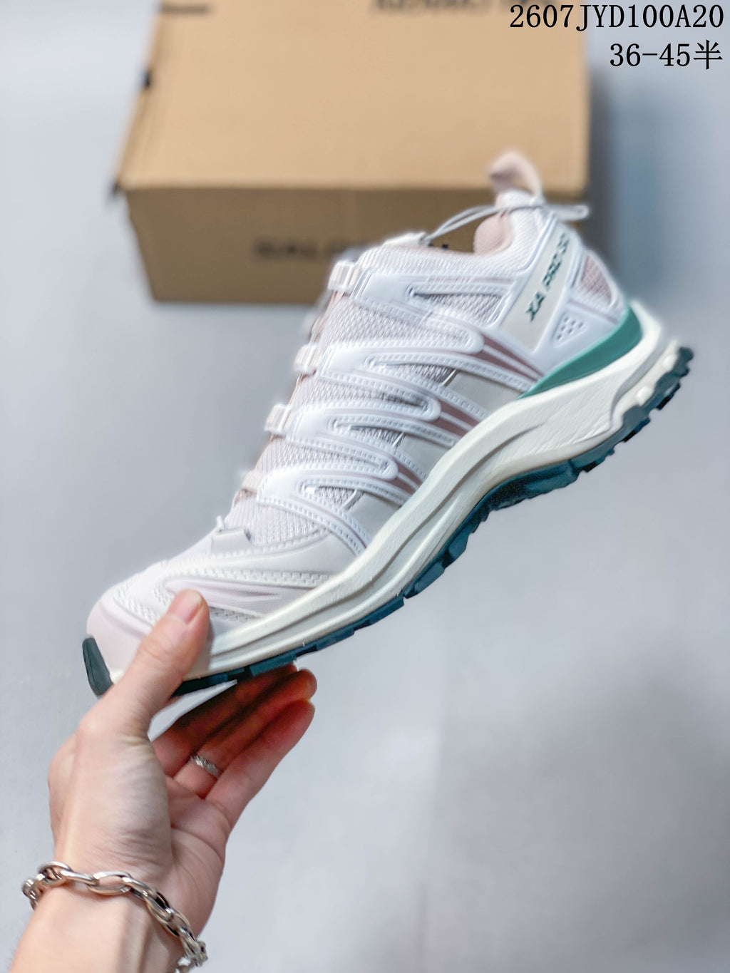 Side view of the Salomon XA PRO 3D sneaker showing layered overlays, mesh upper, white midsole and teal outsole edge.