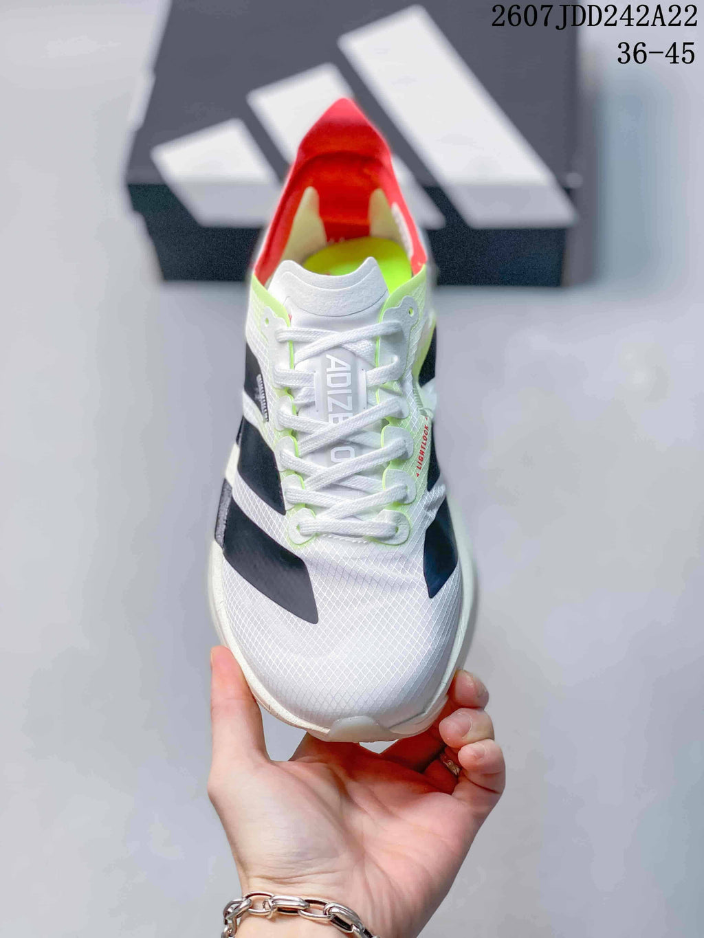 Top view of the white lace-up sneaker with black side details, neon green trim, and red interior accents.