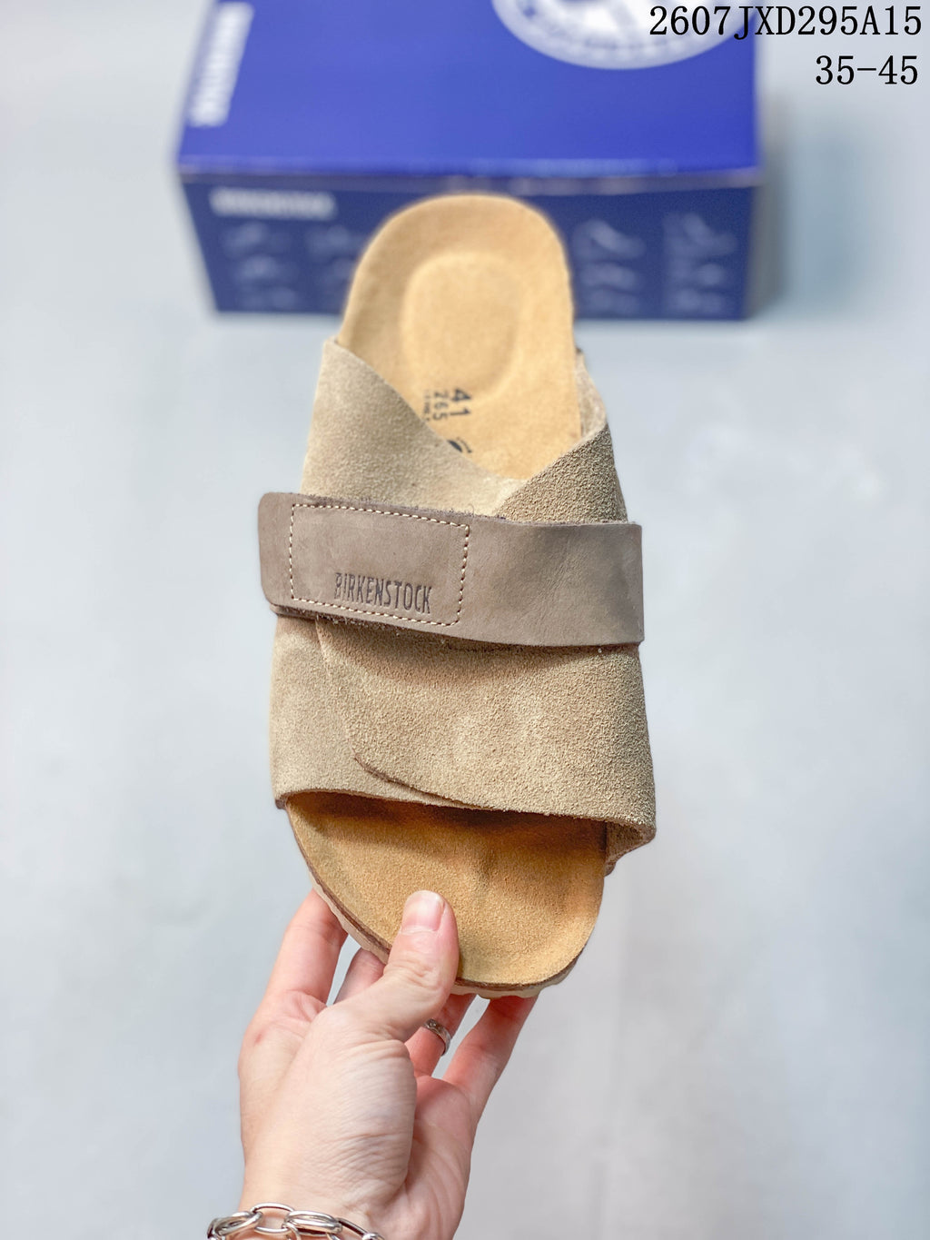 Top view of one taupe sandal showing the wide adjustable strap and contoured footbed.