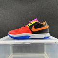 Side view of a multicolor Nike low-top sneaker with red, black, orange, yellow, purple, white, and blue details.