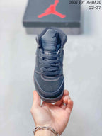 Front view of the dark high-top sneaker showing the padded tongue, lace-up closure, and contrasting white stitching.