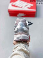 Rear view of a silver and white sneaker showing the padded heel, layered upper, and textured outsole; size range 36–42.5 is visible.