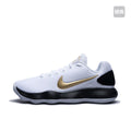 Side view of a white Nike basketball sneaker with a gold Swoosh, black heel panel and black-and-white sole.